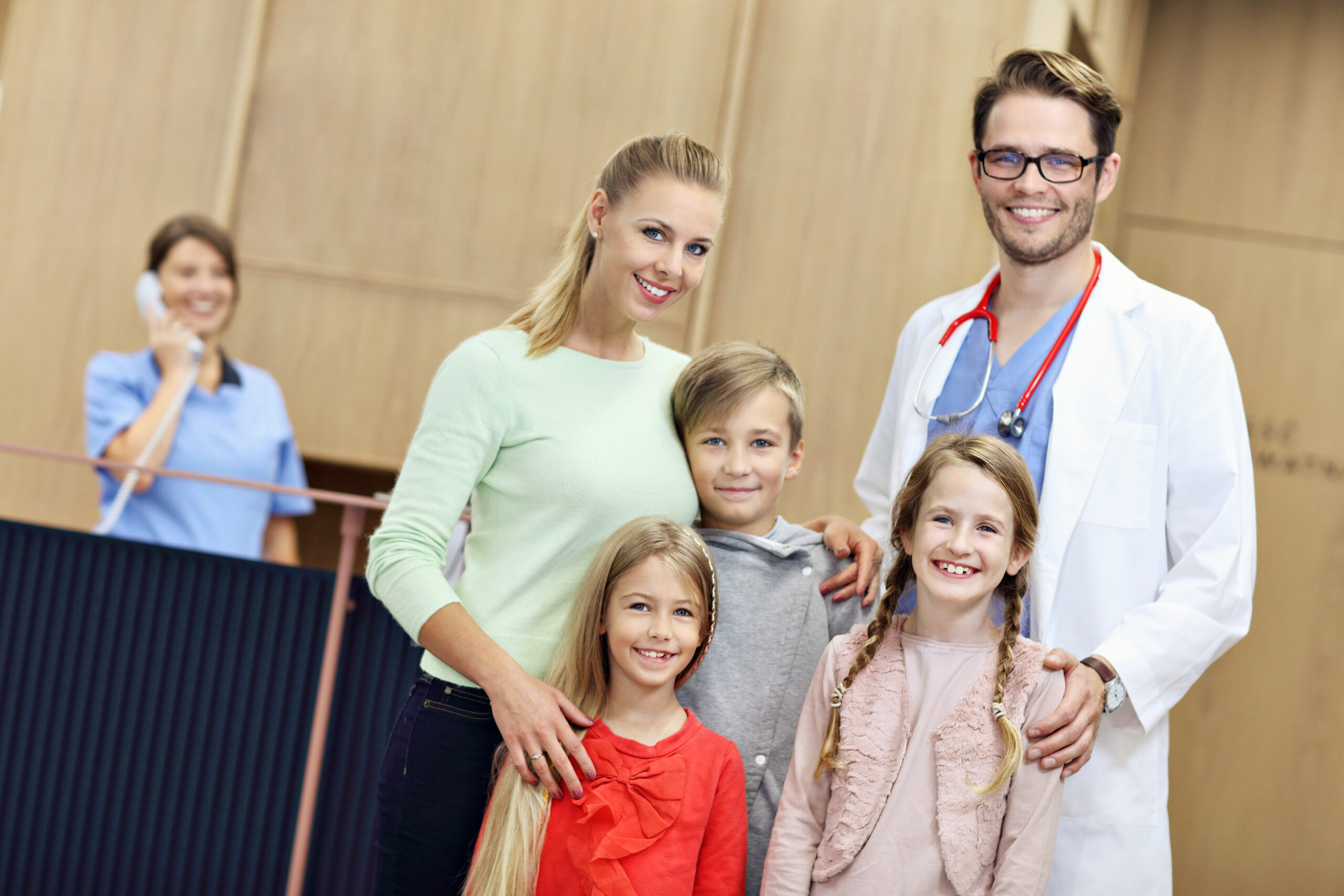 Mother and children together in hospital with doctor