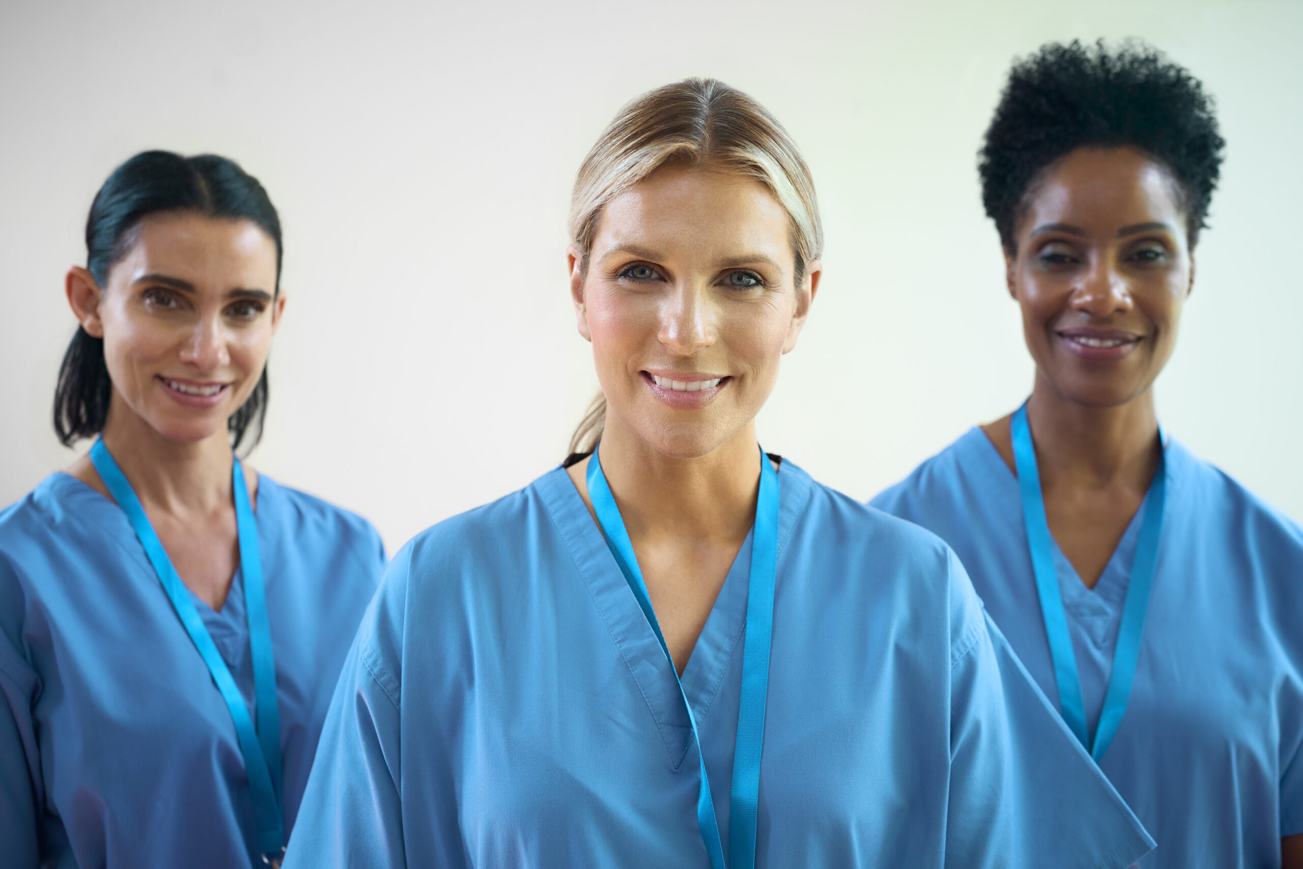 Portrait Of Mature Female Multi Cultural Medical Team Wearing Scrubs In Hospital