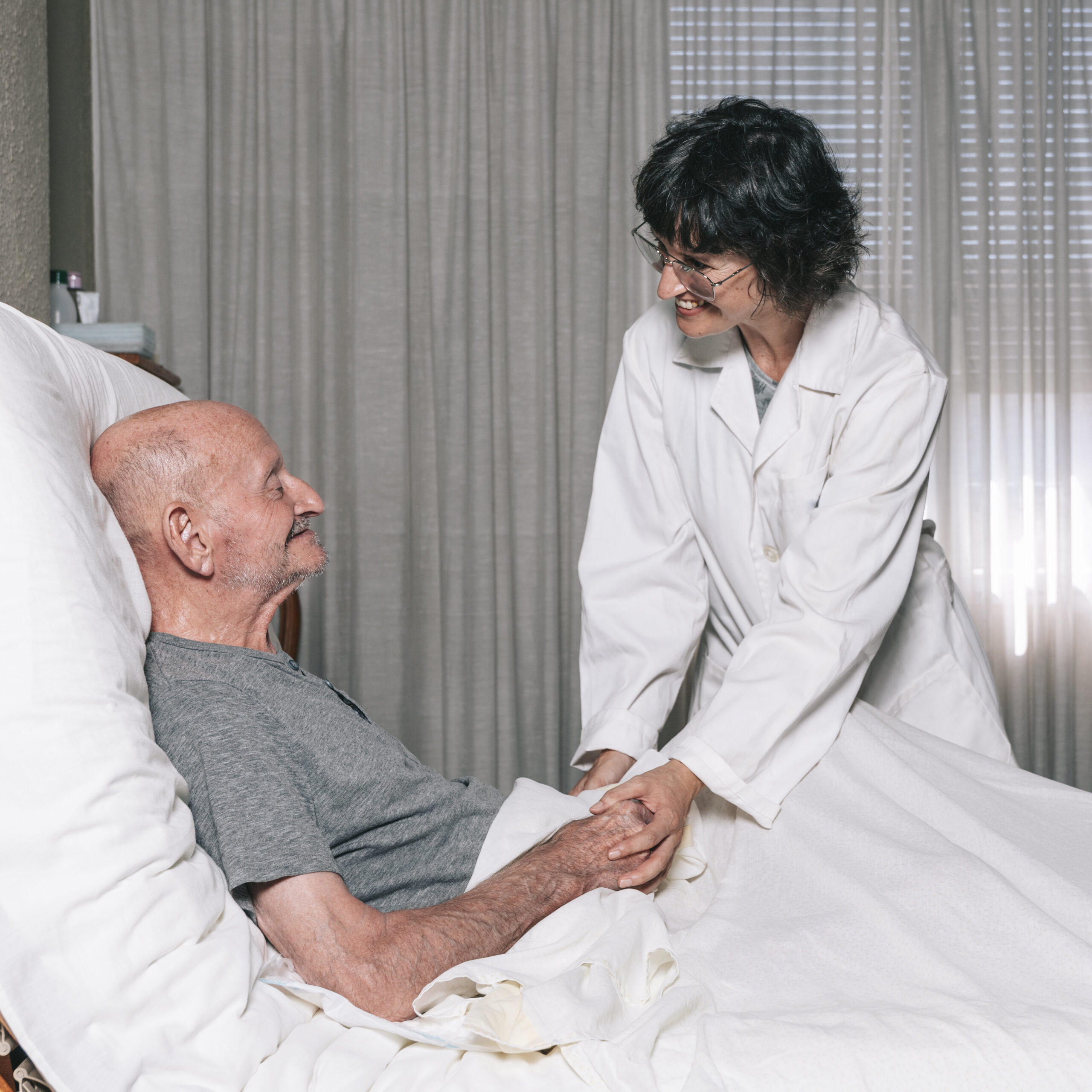 smiling-nurse-holds-the-hands-of-an-elderly-patien-2025-01-09-01-45-18-utc