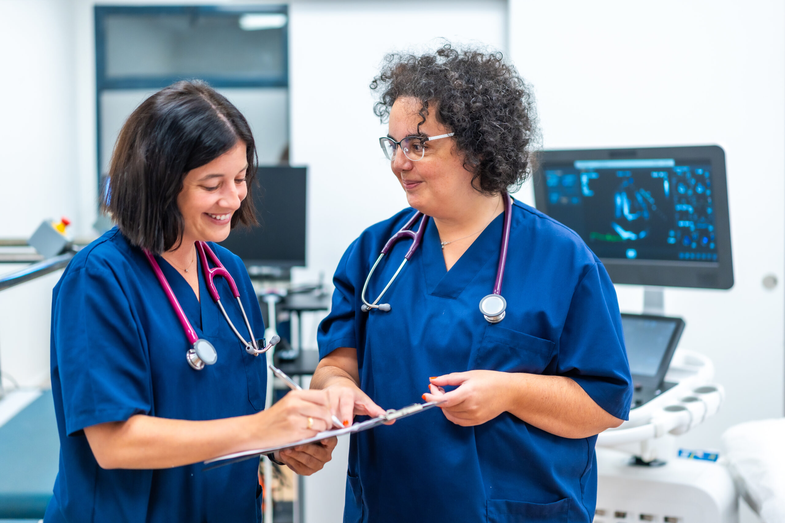 Team of cardiologists doing paperwork standing on the hospital