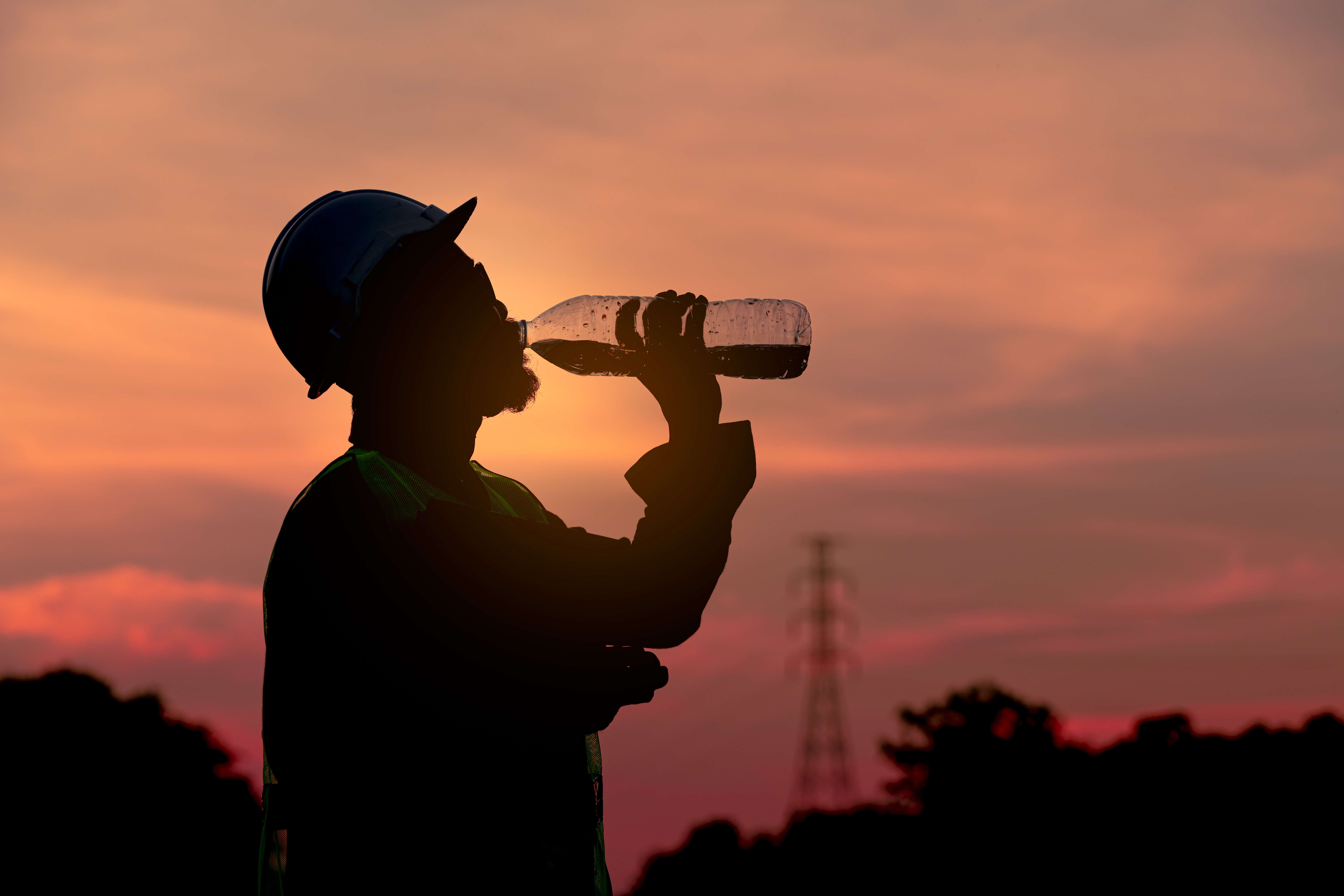silhouette-engineer-drinking-fresh-water-when-he-f-2025-03-14-00-37-51-utc
