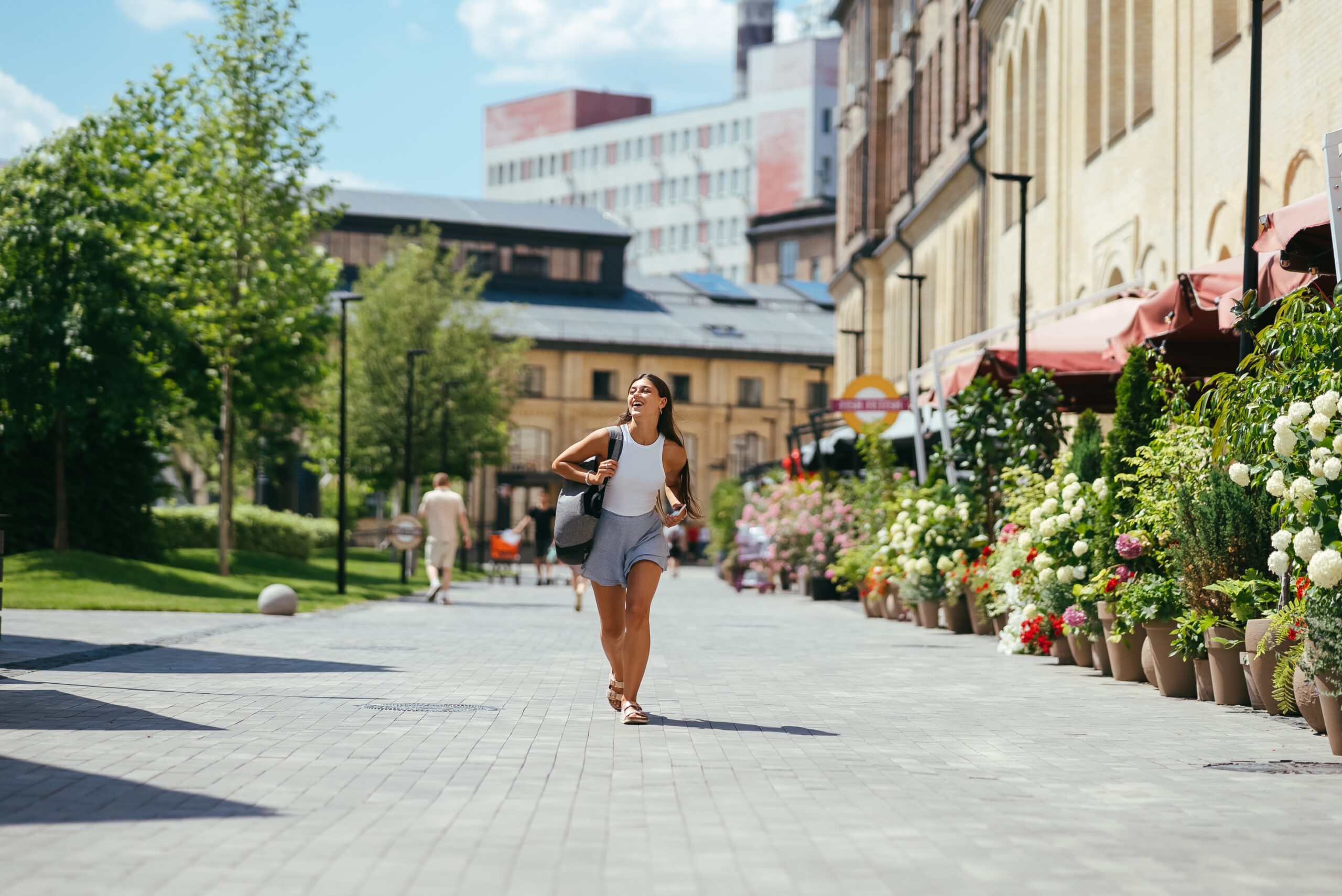 Young woman with backpack walks around the city.