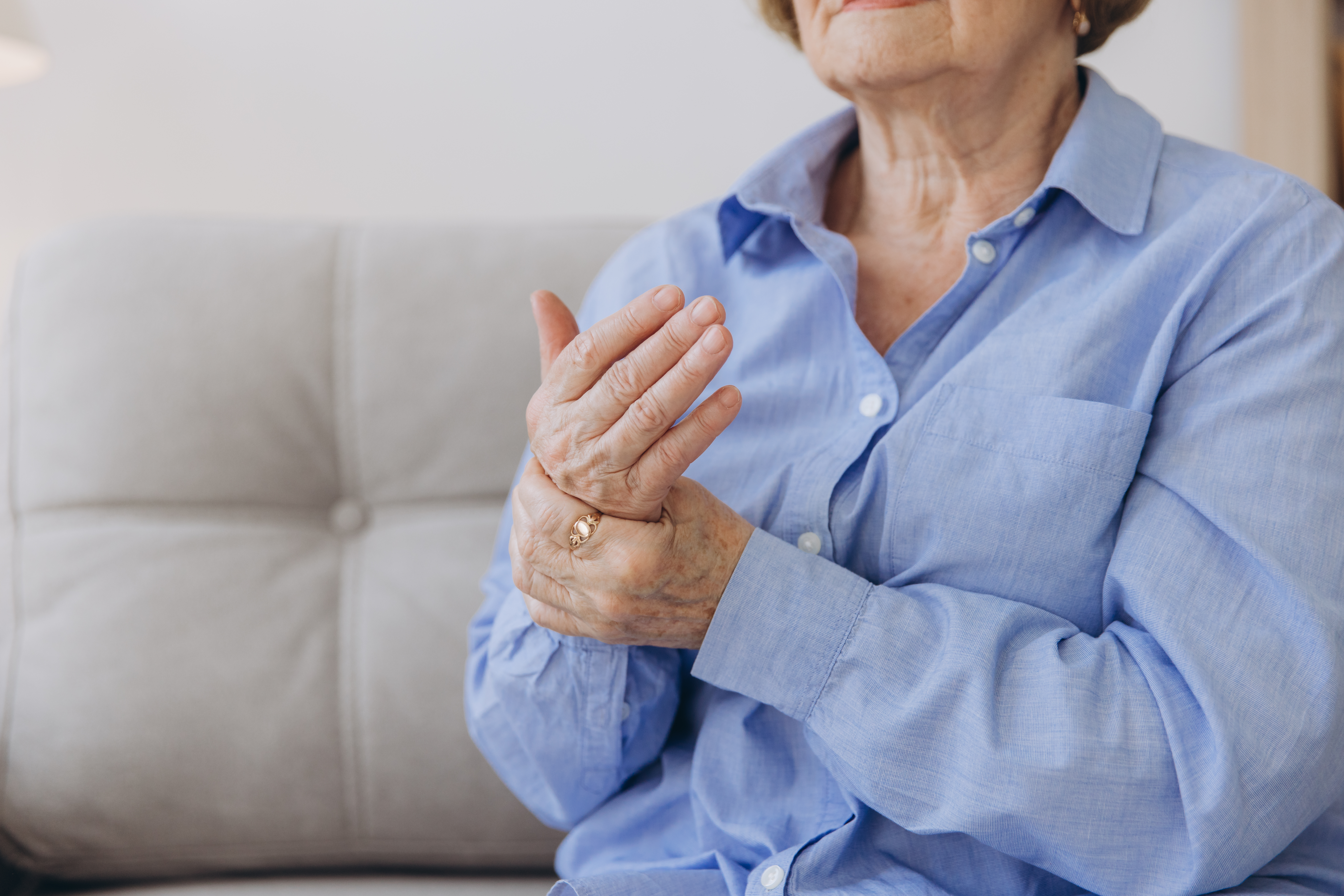 Elderly woman suffering from pain in hand, close up