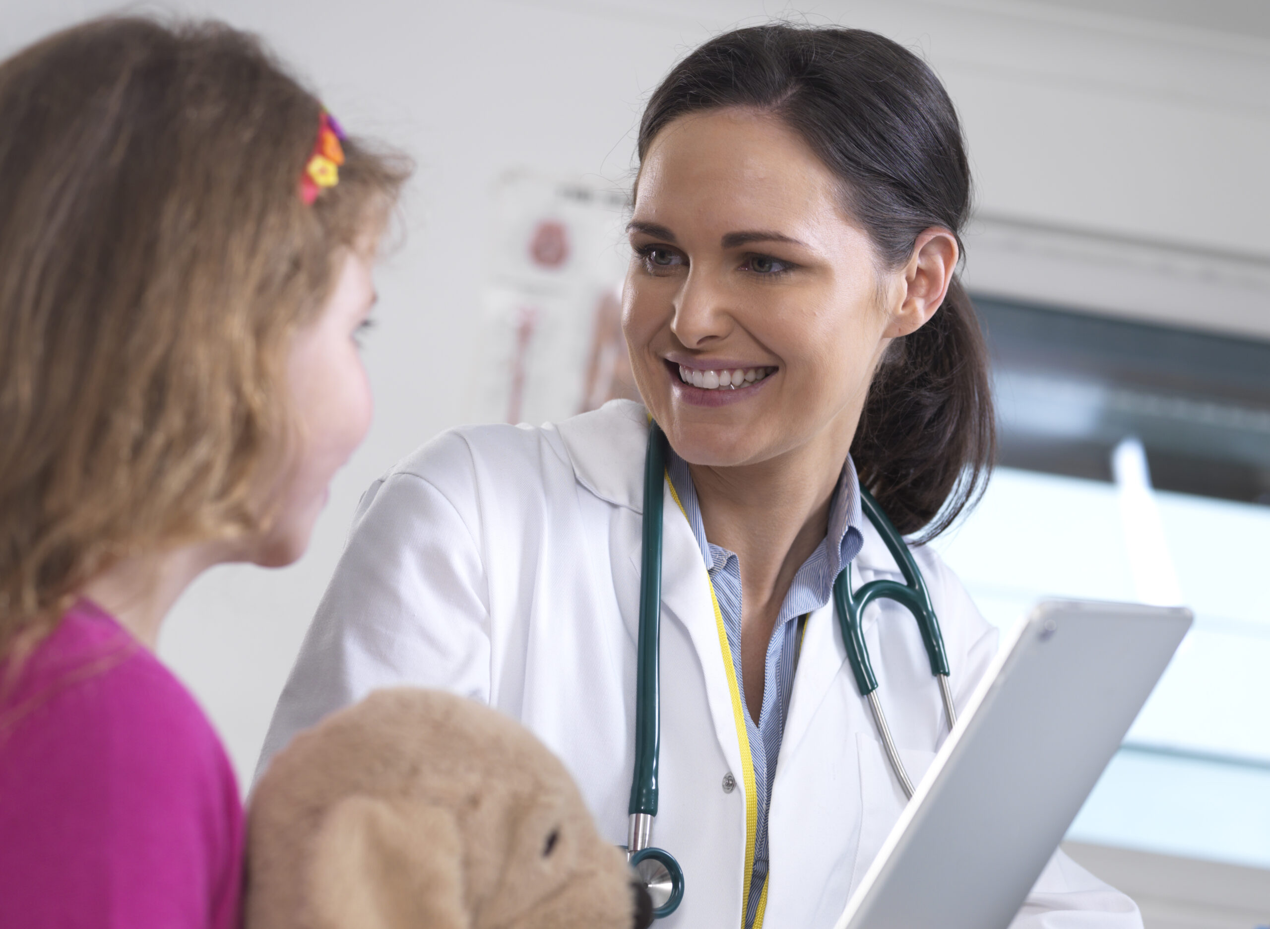 Female doctor showing a young female patient her lab results on a digital tablet in the clinic
