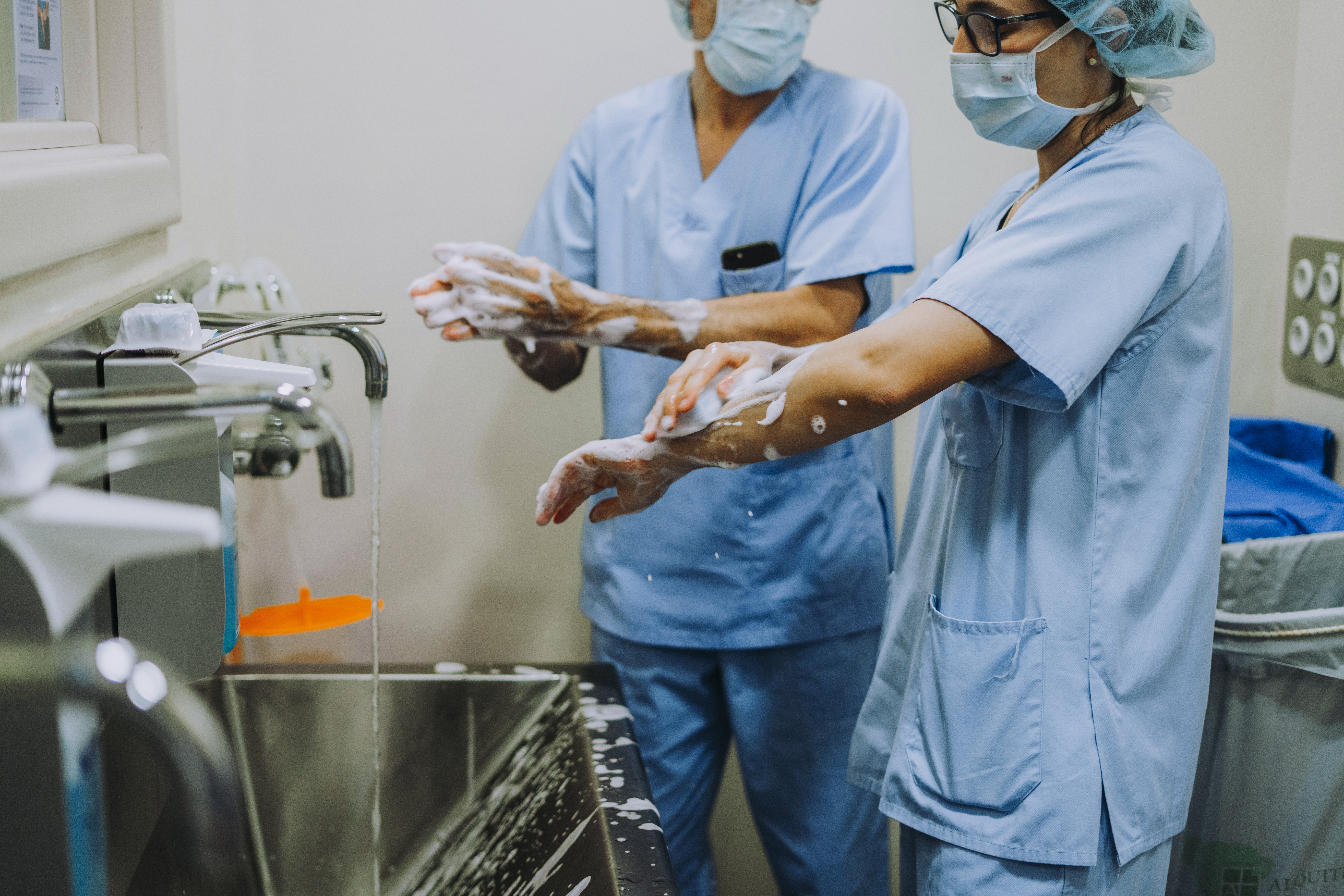 Unrecognizable doctor washing hands before operating