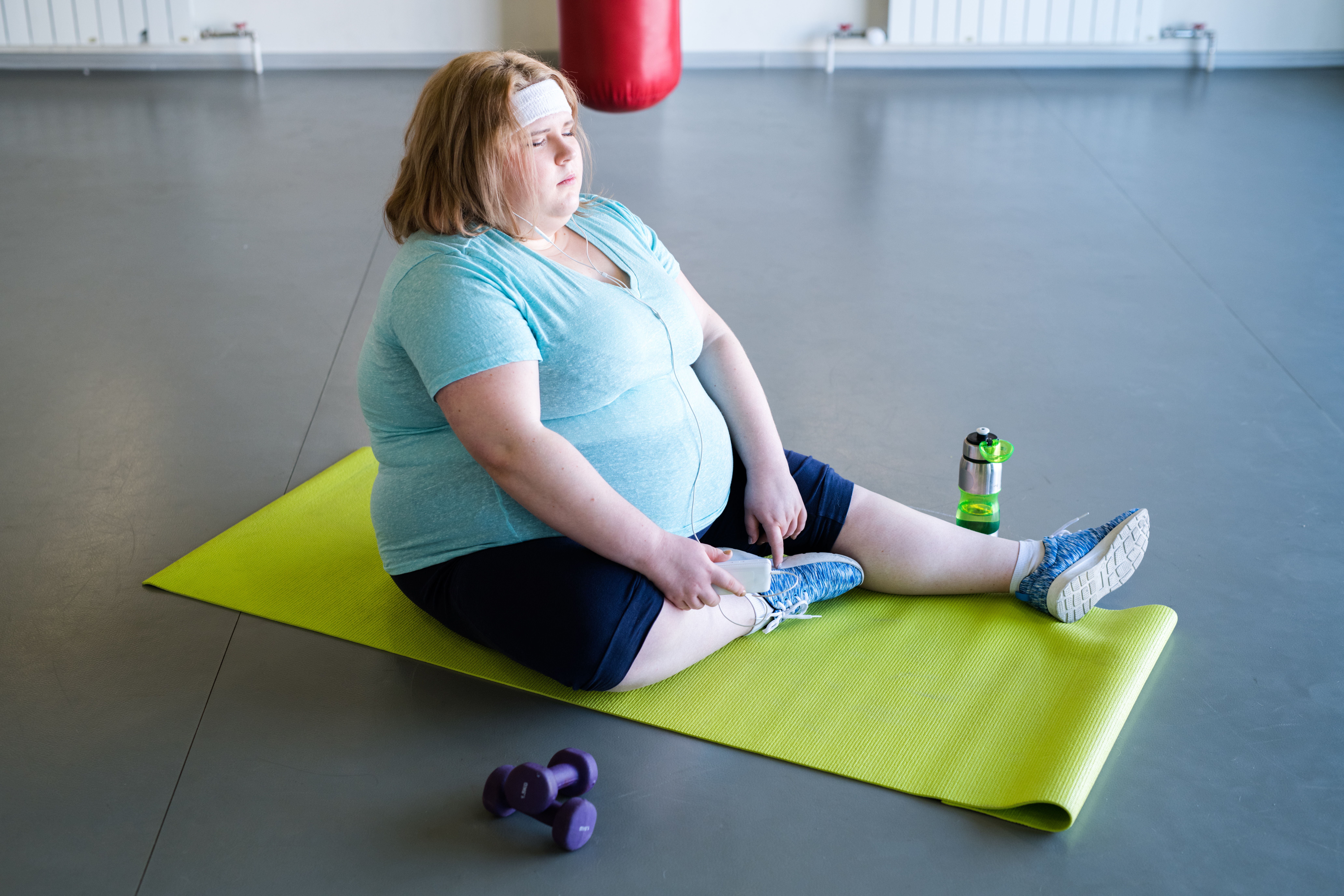 Obese Woman Resting after Workout