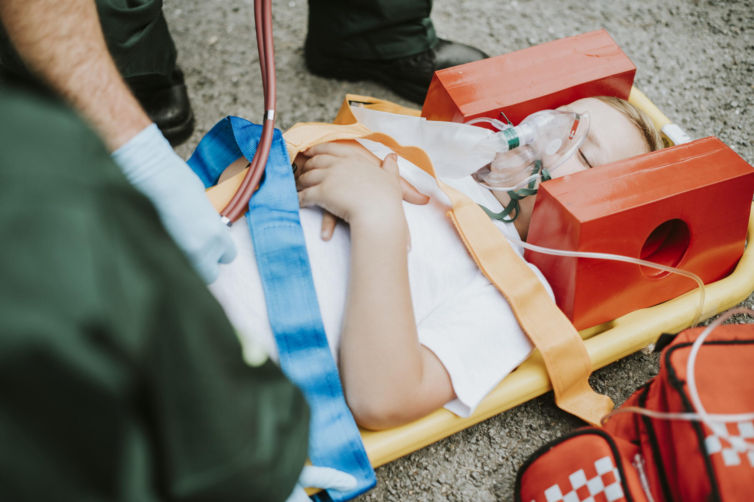 Paramedic team rescuing a young critical patient