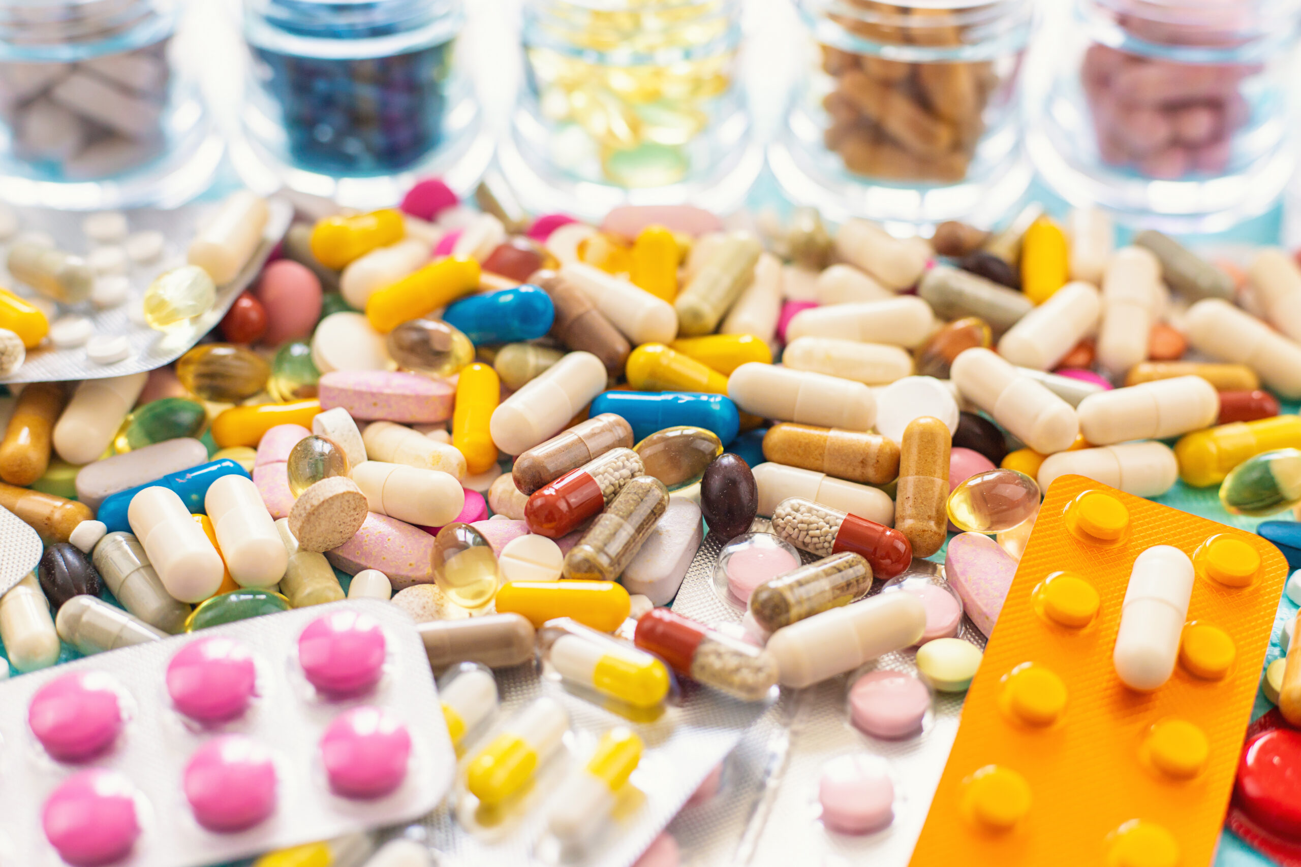 Various tablets and capsules on the table. Selective focus.